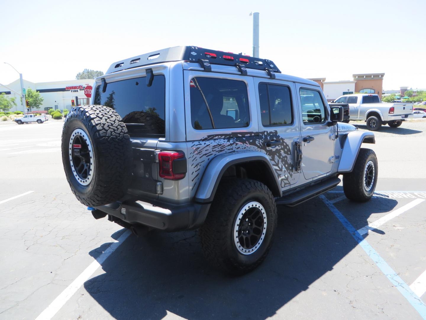 2021 SILVER /BLACK Jeep Wrangler Unlimited Rubicon 4XE 4d SUV 4wd (1C4JJXR63MW) with an 2.0L L4 DOHC 16V TURBO engine, automatic transmission, located at 2630 Grass Valley Highway, Auburn, CA, 95603, (530) 508-5100, 38.937893, -121.095482 - Impressive 4xe Rubicon with a ton of extras that include Fox 3.0 internal bypass front and rear shocks, 315 BFG KO2 tires, Warn winch, Factor 55 Ultra hook, Front bumper stinger, Rigid Pods on front bumper, Rigid A series lights in the roof rack, DV8 lockable hood pins, Westin Running boards, Fury d - Photo#4